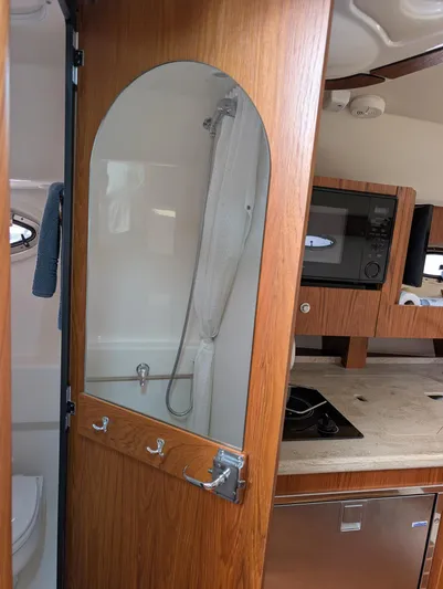 Finale Yacht Photos Pics Interior of 2015 Tiara Yachts 3100 Open, featuring a compact shower and kitchenette.