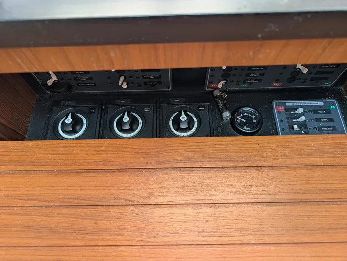 Finale Yacht Photos Pics Control panel of 2015 Tiara Yachts 3100 Open with wooden finish and gauges.