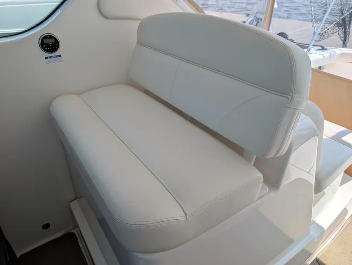 Finale Yacht Photos Pics 2015 Tiara Yachts 3100 Open interior seating, featuring white cushioned bench.