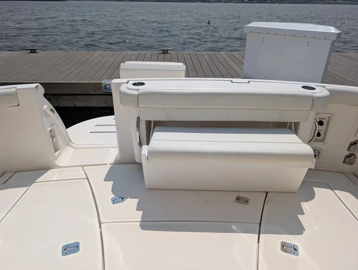 Finale Yacht Photos Pics 2015 Tiara Yachts 3100 Open boat with white seating, docked by the water.