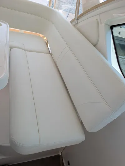 Finale Yacht Photos Pics 2015 Tiara Yachts 3100 Open interior seating, featuring white cushioned bench.