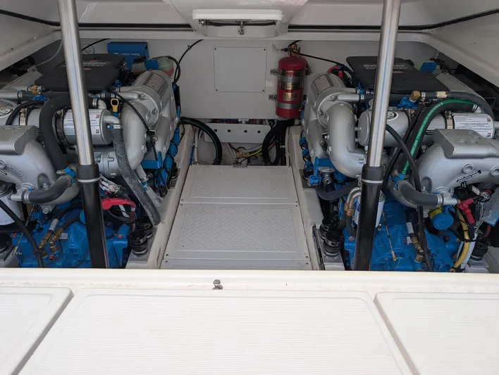 Finale Yacht Photos Pics Engine room of 2015 Tiara Yachts 3100 Open, featuring dual engines and fire extinguisher.
