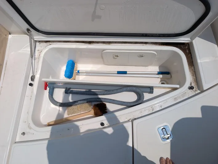Finale Yacht Photos Pics Open storage compartment on 2015 Tiara Yachts 3100 Open with cleaning tools inside.
