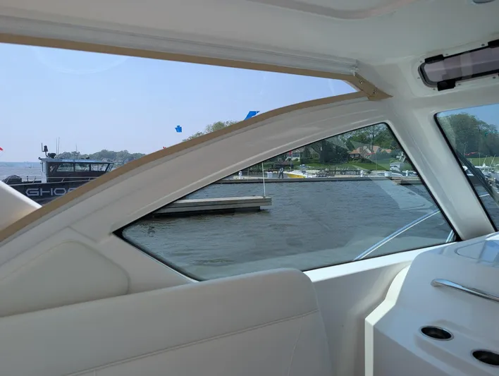 Finale Yacht Photos Pics Interior view of 2015 Tiara Yachts 3100 Open, overlooking marina through window.