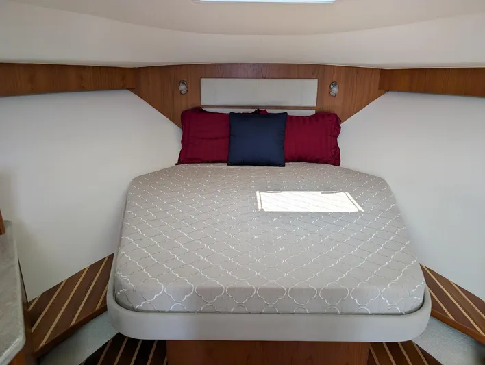 Finale Yacht Photos Pics 2015 Tiara Yachts 3100 Open cabin with bed, pillows, and wooden accents.