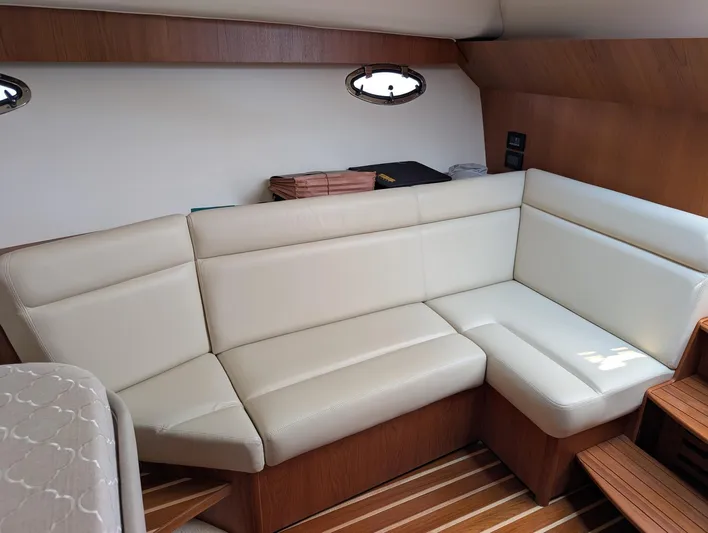 Finale Yacht Photos Pics 2015 Tiara Yachts 3100 Open interior with cream leather seating and wooden accents.