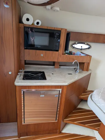 Finale Yacht Photos Pics Compact kitchen area in a 2015 Tiara Yachts 3100 Open, featuring a microwave and sink.