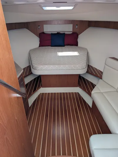 Finale Yacht Photos Pics 2015 Tiara Yachts 3100 Open cabin interior with wood flooring and cozy bed.