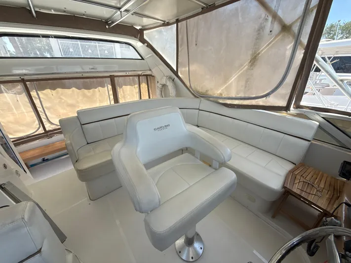  Yacht Photos Pics 2001 Carver 396 Motor Yacht interior with white seating and helm chair.