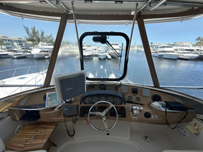  Yacht Photos Pics 2001 Carver 396 Motor Yacht helm with navigation equipment, overlooking marina with docked boats.