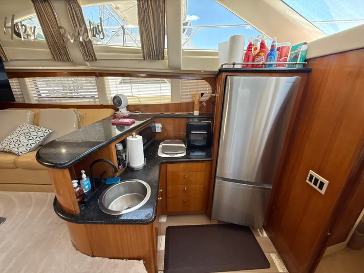  Yacht Photos Pics Interior of 2001 Carver 396 Motor Yacht with kitchenette and stainless steel appliances.