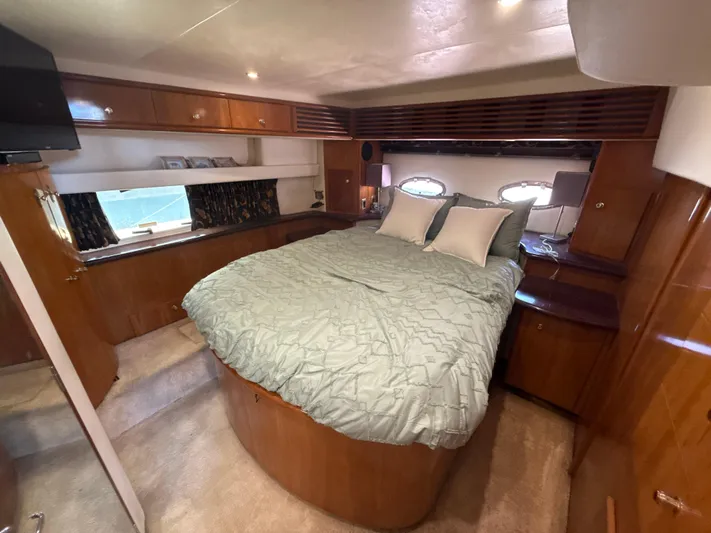  Yacht Photos Pics Luxurious 2001 Carver 396 Motor Yacht bedroom with cozy bed and elegant wood finishes.