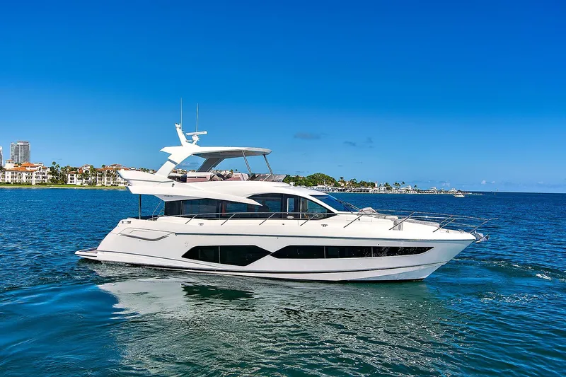 Exit Yacht Photos Pics 2019 Sunseeker Manhattan 66 yacht cruising on clear blue waters.