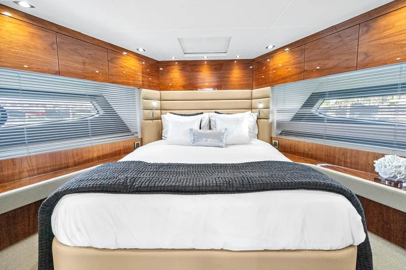 Exit Yacht Photos Pics Luxurious bedroom interior of 2019 Sunseeker Manhattan 66 yacht with elegant wood finishes.