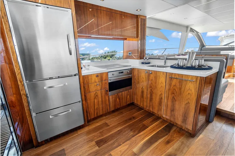Exit Yacht Photos Pics Luxurious kitchen interior of 2019 Sunseeker Manhattan 66 yacht with modern appliances.