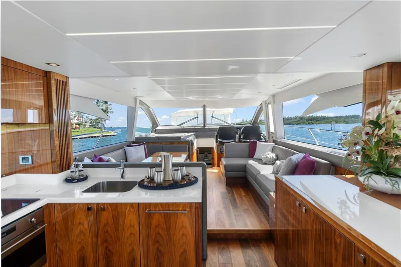 Exit Yacht Photos Pics Luxurious interior of 2019 Sunseeker Manhattan 66 yacht with elegant wood finishes and scenic ocean view.