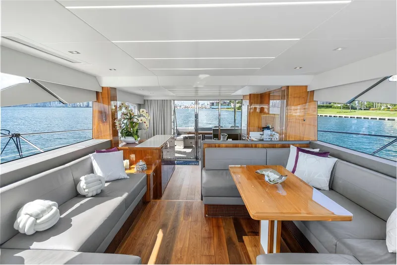 Exit Yacht Photos Pics Luxurious interior of 2019 Sunseeker Manhattan 66 yacht with elegant seating and scenic water views.