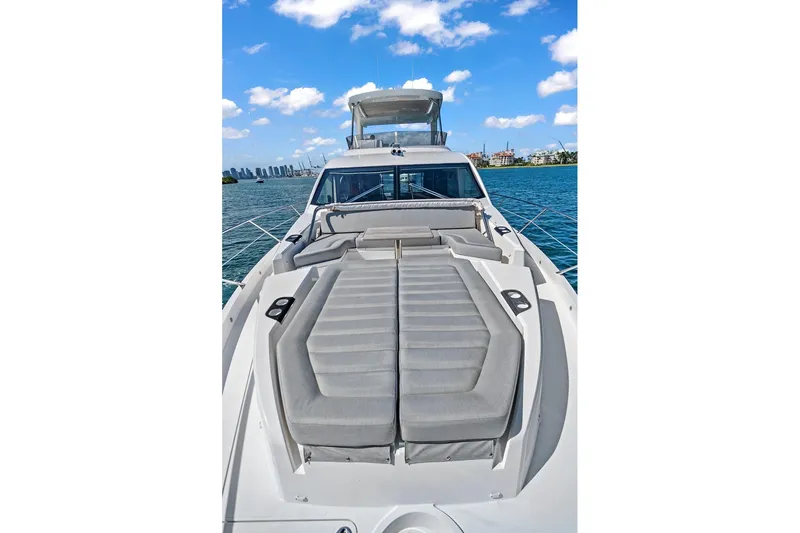 Exit Yacht Photos Pics 2019 Sunseeker Manhattan 66 yacht with luxurious deck seating, cruising on a sunny day.