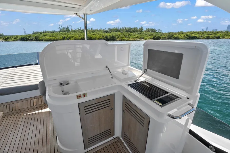Exit Yacht Photos Pics Outdoor kitchen on 2019 Sunseeker Manhattan 66 yacht with scenic water view.