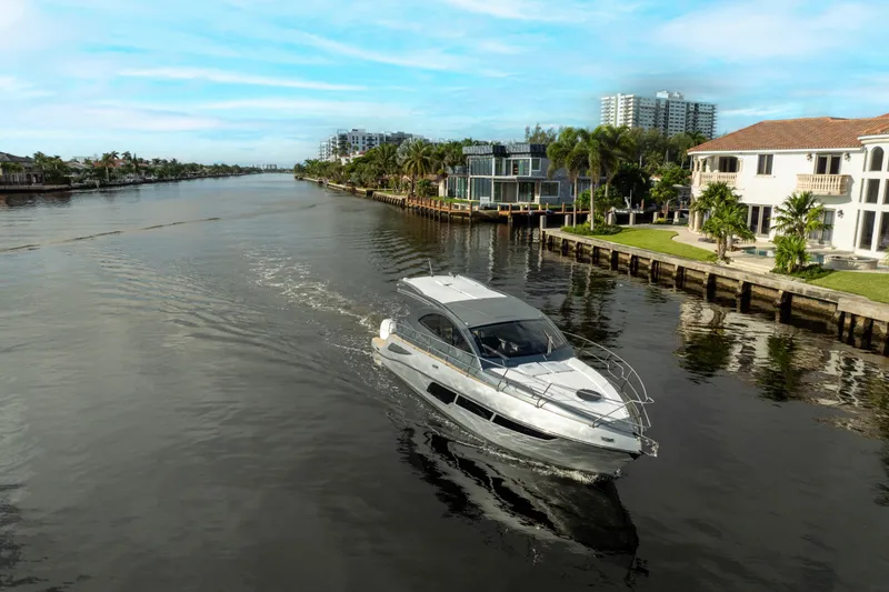  Yacht Photos Pics 2025 Valiatt 410HT luxury yacht cruising along a scenic waterfront.