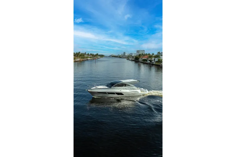  Yacht Photos Pics Valiatt 410HT 2025 yacht cruising on a scenic waterway under a clear blue sky.