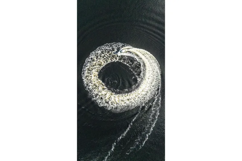  Yacht Photos Pics Aerial view of Valiatt 410HT boat creating circular wake pattern on water, 2025 model.