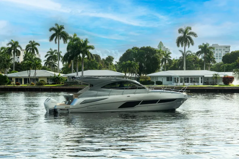  Yacht Photos Pics Luxury Valiatt 410HT yacht cruising on a serene waterway, surrounded by palm trees, 2025 model.
