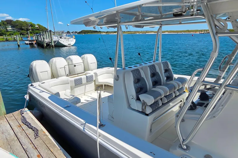 Impatient Yacht Photos Pics 2016 SeaVee 390Z boat docked, featuring triple outboard engines and spacious seating.