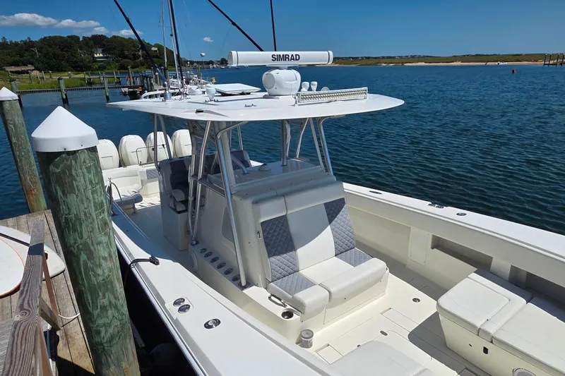 Impatient Yacht Photos Pics 2016 SeaVee 390Z boat docked, featuring a sleek design and spacious seating.