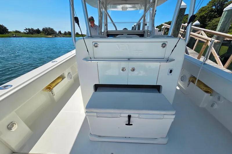 Impatient Yacht Photos Pics 2016 SeaVee 390Z boat interior with storage and seating, docked by a scenic waterway.