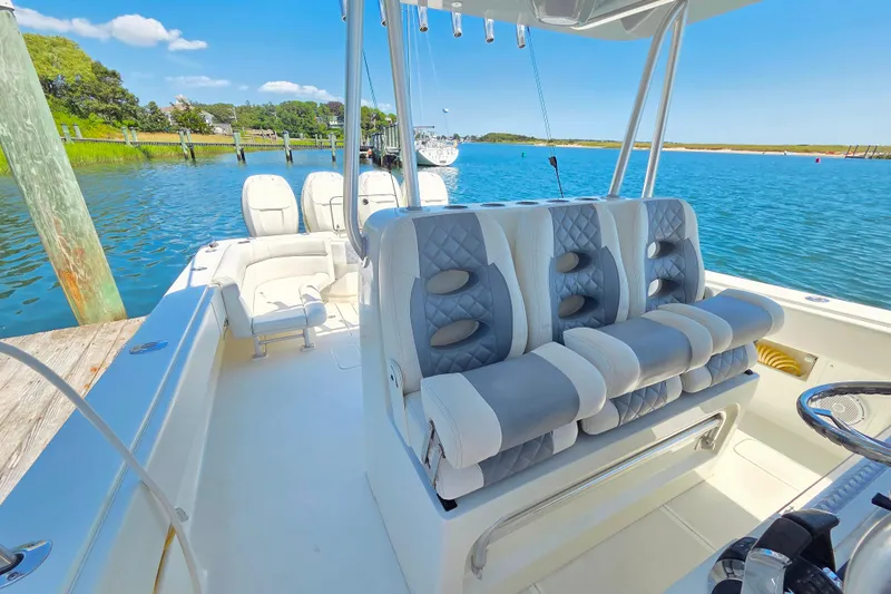Impatient Yacht Photos Pics 2016 SeaVee 390Z boat interior with luxurious seating, docked by a scenic waterfront.