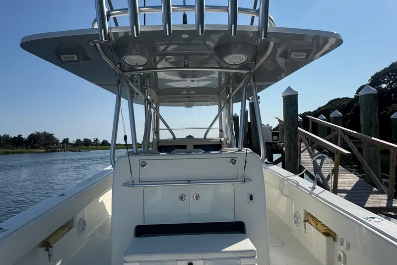 Impatient Yacht Photos Pics 2016 SeaVee 390Z boat docked by a wooden pier on a sunny day.