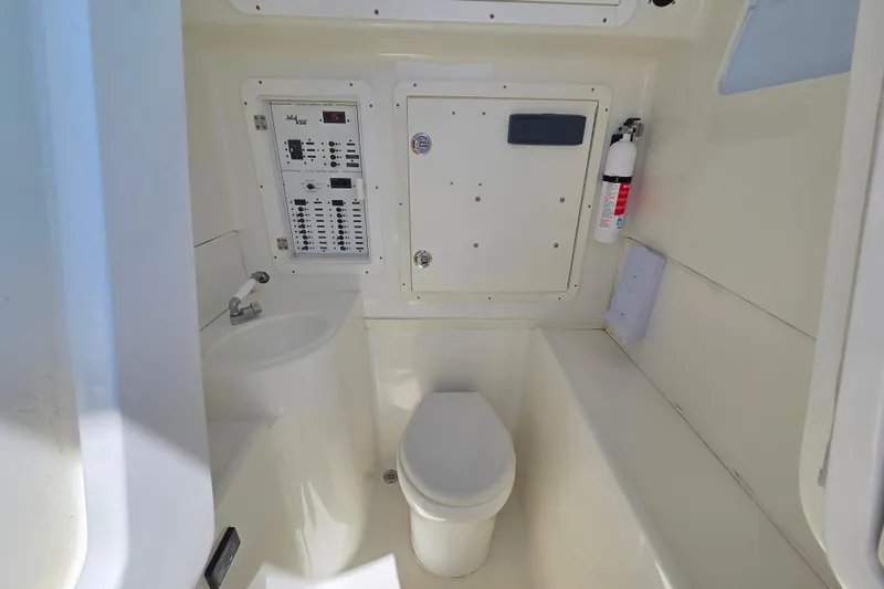 Impatient Yacht Photos Pics 2016 SeaVee 390Z boat interior with toilet, sink, control panel, and fire extinguisher.