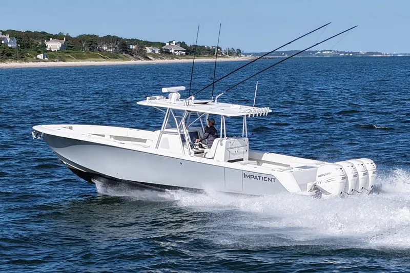 Impatient Yacht Photos Pics 2016 SeaVee 390Z boat cruising on the ocean near a coastal shoreline.
