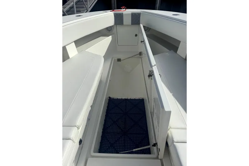 Impatient Yacht Photos Pics 2016 SeaVee 390Z boat interior with open storage compartment and cushioned seating.