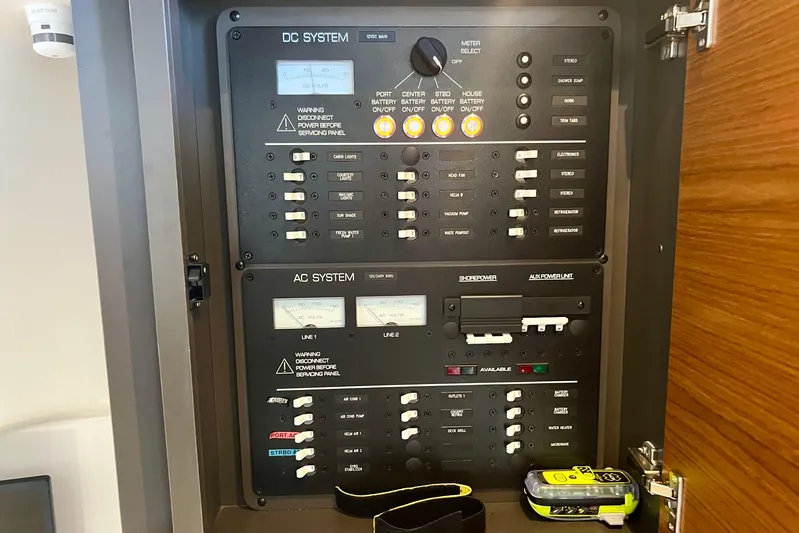 Ivernia Yacht Photos Pics Electrical control panel on a 2020 Tiara Yachts 43 LS, featuring DC and AC systems.