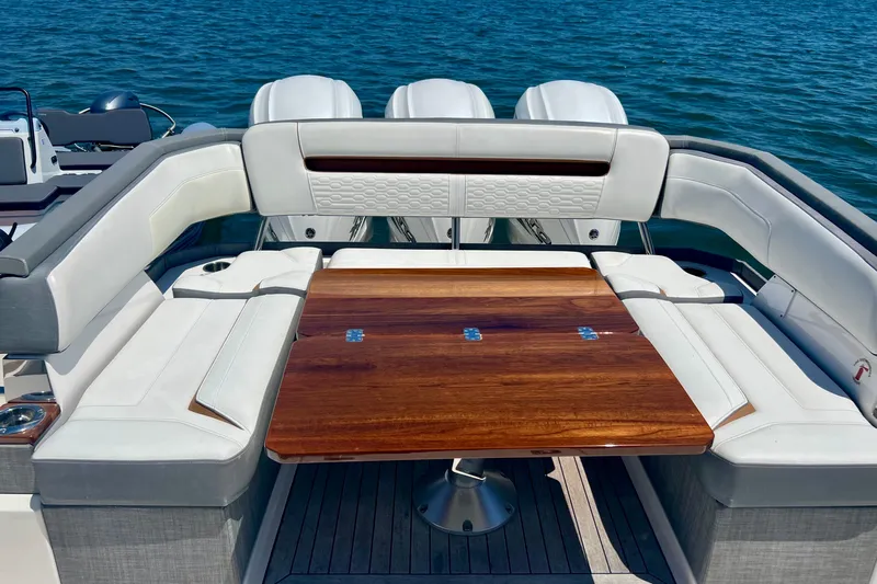 Ivernia Yacht Photos Pics 2020 Tiara Yachts 43 LS luxury seating area with wooden table on water.