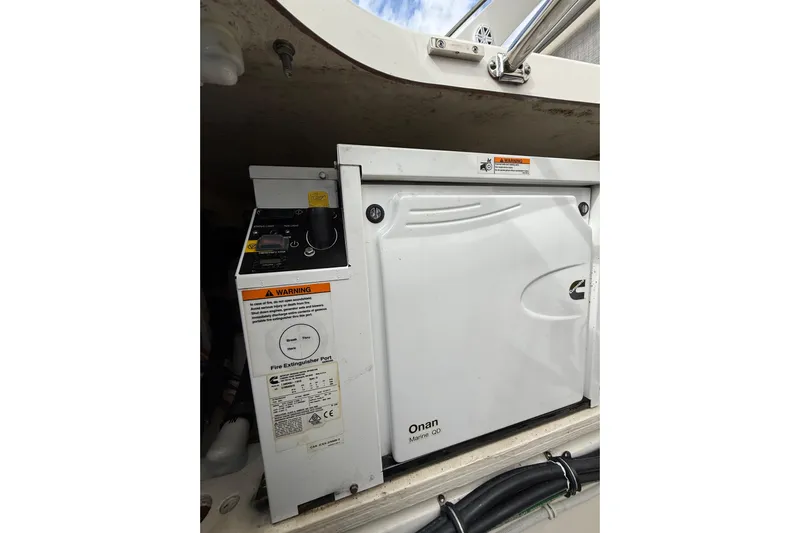 Ivernia Yacht Photos Pics Onan Marine QD generator in 2020 Tiara Yachts 43 LS, with control panel and warning labels.