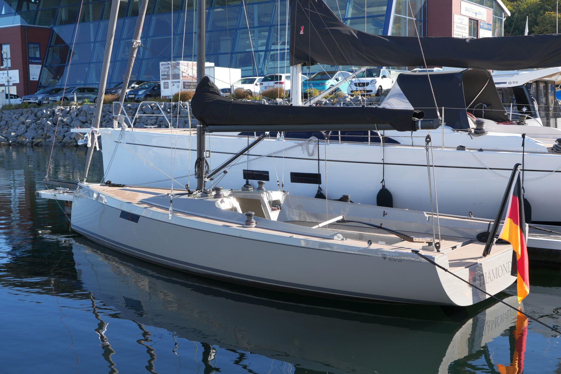 2023 Saffier SE 24 Lite sailboat docked in marina, featuring sleek design and German flag.