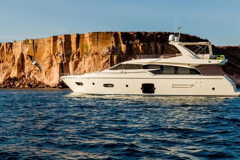  Yacht Photos Pics Ferretti Yachts 720 (2013) cruising near rocky cliffs in clear blue waters.