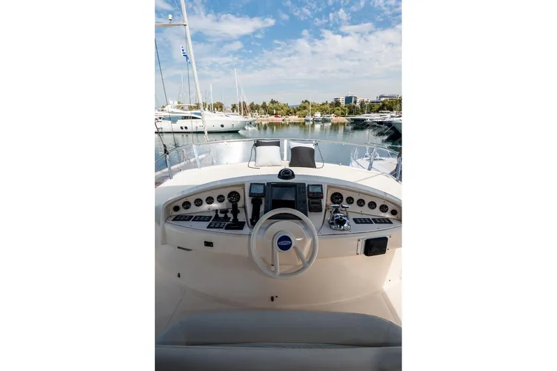  Yacht Photos Pics Cockpit view of 2004 Aicon 56 yacht with steering wheel and control panel.