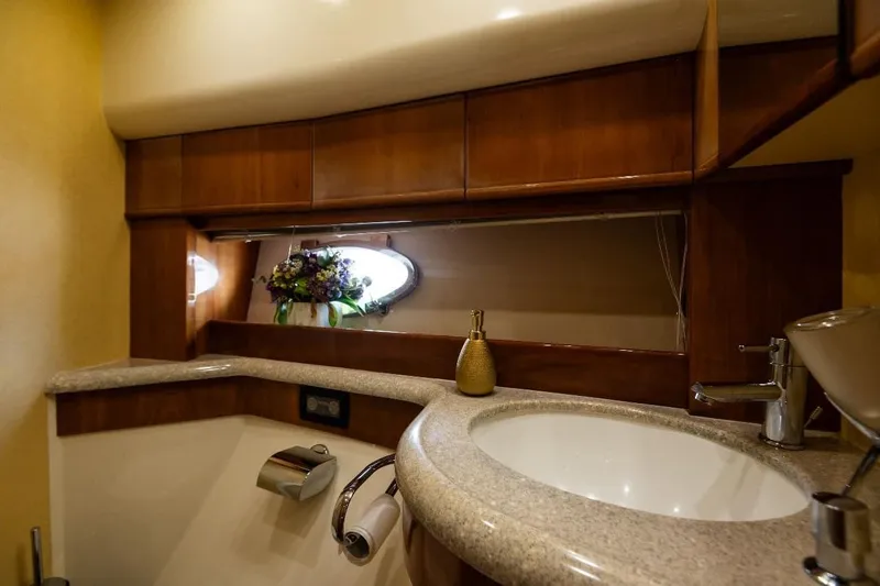  Yacht Photos Pics Luxurious bathroom interior of 2004 Aicon 56 yacht with elegant wood and marble finishes.