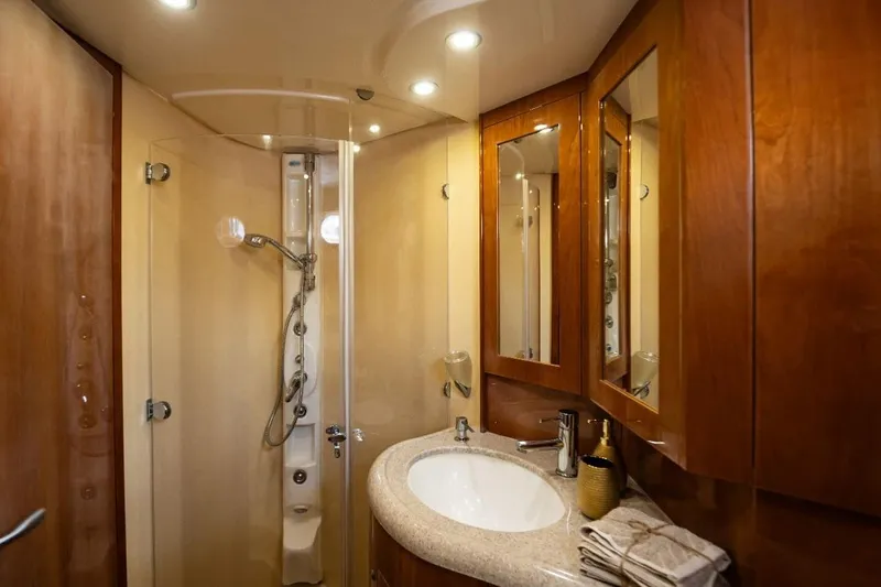  Yacht Photos Pics Luxurious bathroom in 2004 Aicon 56 yacht with wooden cabinetry and modern fixtures.