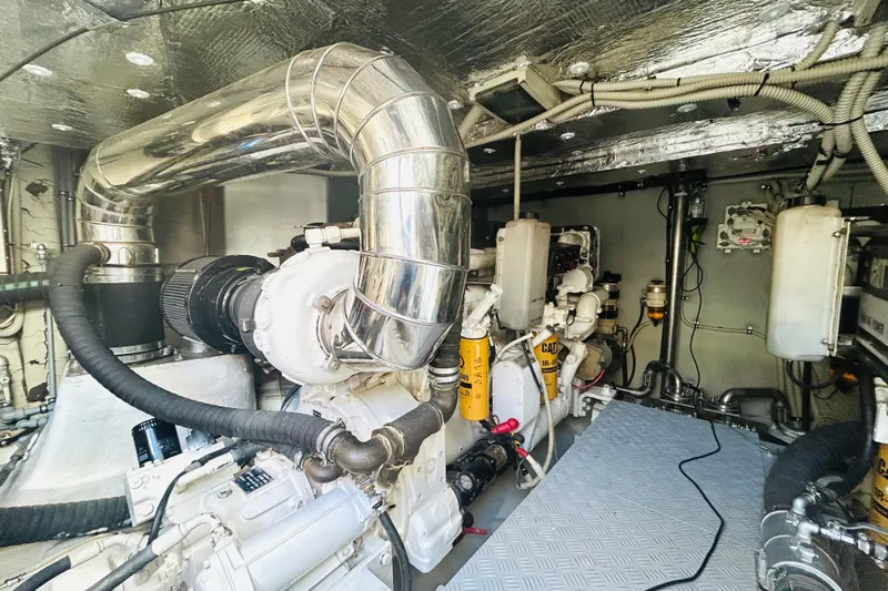  Yacht Photos Pics Engine room of a 2004 Aicon 56 yacht, featuring complex machinery and piping.