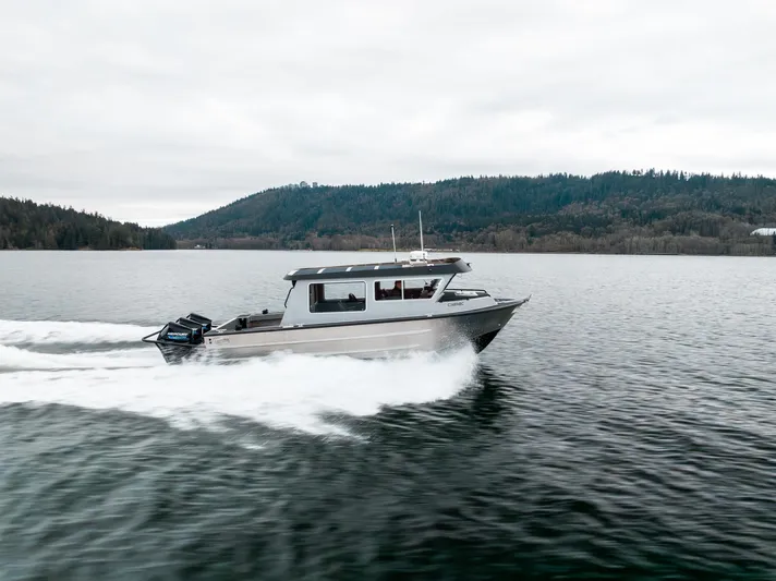  Yacht Photos Pics 2023 Liquid Metal Marine Maquinna Crew boat cruising on a serene lake.