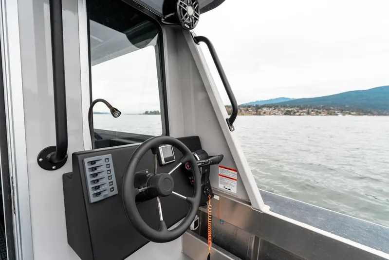  Yacht Photos Pics 2023 Liquid Metal Marine Maquinna Crew boat steering console on open water.