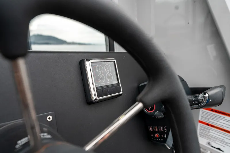  Yacht Photos Pics Steering wheel and control panel of 2023 Liquid Metal Marine Maquinna Crew boat.