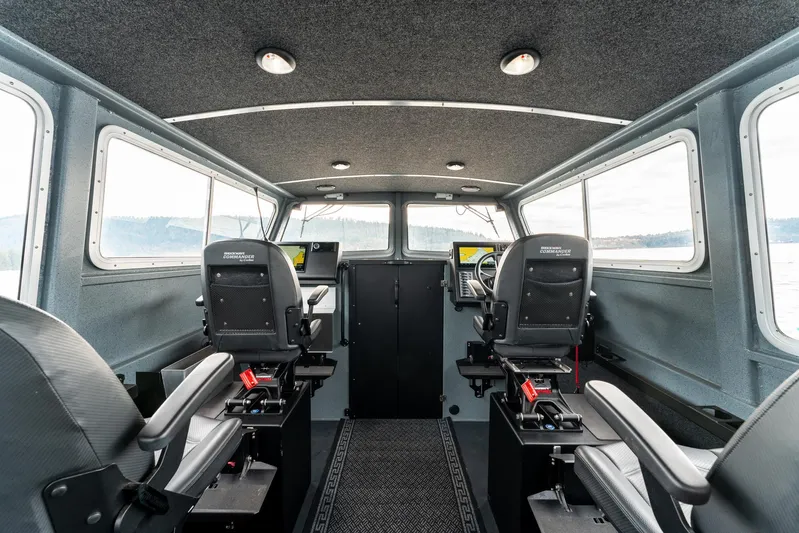  Yacht Photos Pics Interior of 2023 Liquid Metal Marine Maquinna Crew boat with modern seating and controls.