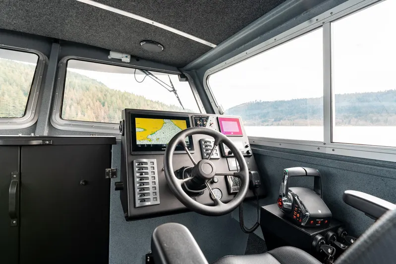  Yacht Photos Pics 2023 Liquid Metal Marine Maquinna Crew boat cockpit with navigation controls and scenic view.