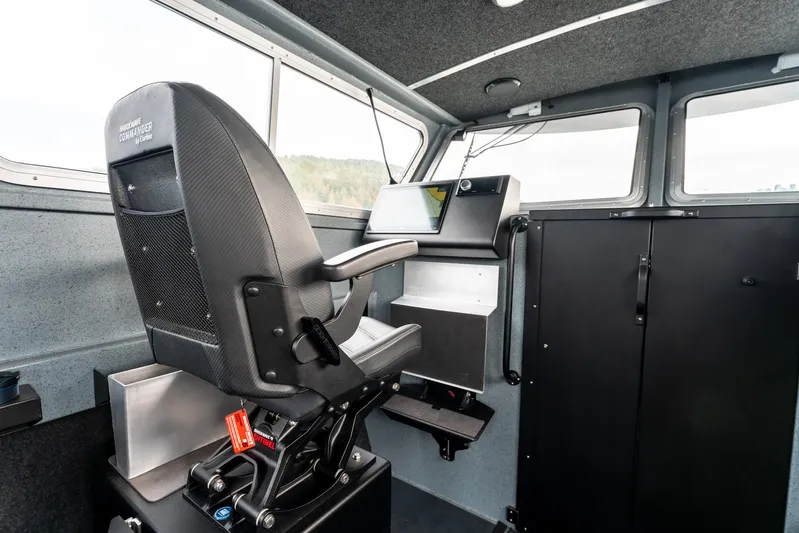  Yacht Photos Pics Interior of 2023 Liquid Metal Marine Maquinna Crew boat, featuring captain's chair and control panel.